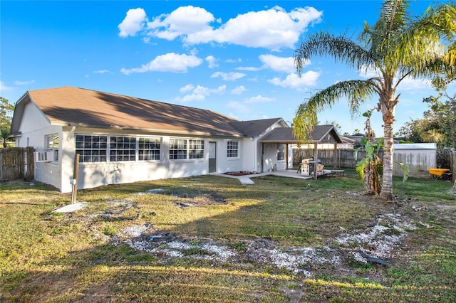 back of property featuring a patio area and a lawn