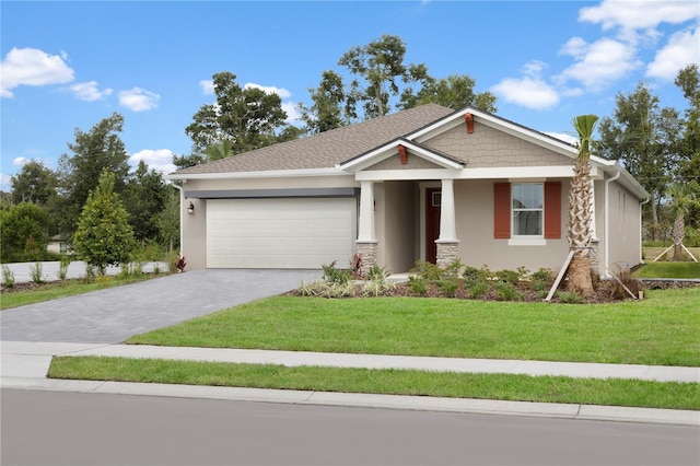 view of front of property with a front yard and a garage