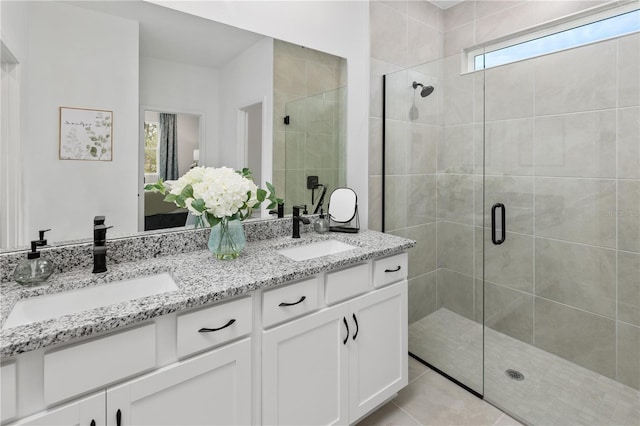 bathroom featuring vanity, tile patterned floors, and walk in shower