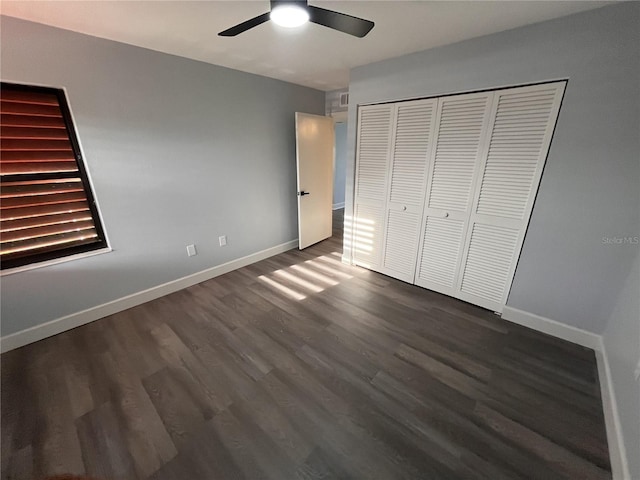 unfurnished bedroom featuring dark hardwood / wood-style flooring, a closet, and ceiling fan