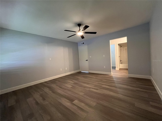 unfurnished bedroom with ceiling fan, dark hardwood / wood-style floors, and ensuite bathroom