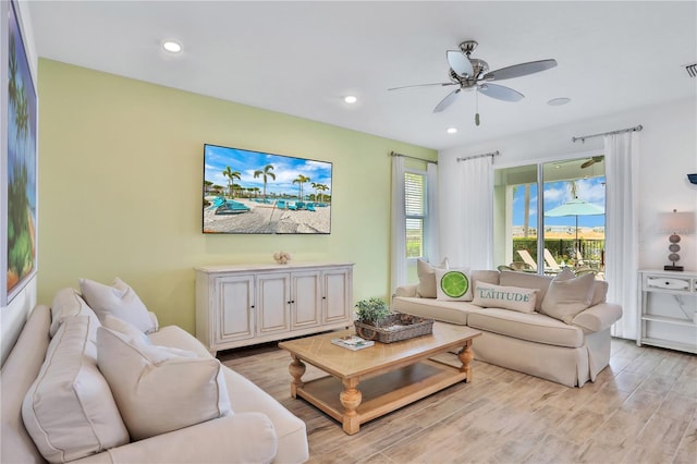 living room with light wood-type flooring and ceiling fan