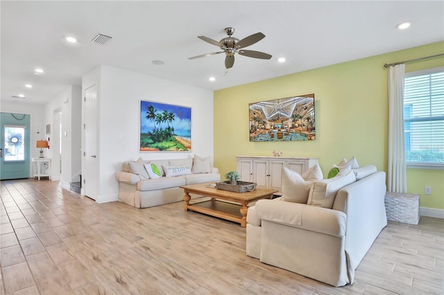 living room featuring light wood-type flooring and ceiling fan