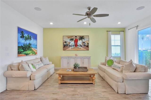 living room featuring ceiling fan and light wood-type flooring