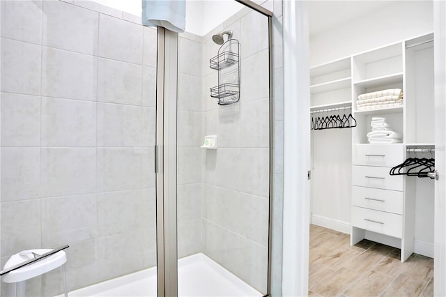 bathroom with wood-type flooring and walk in shower