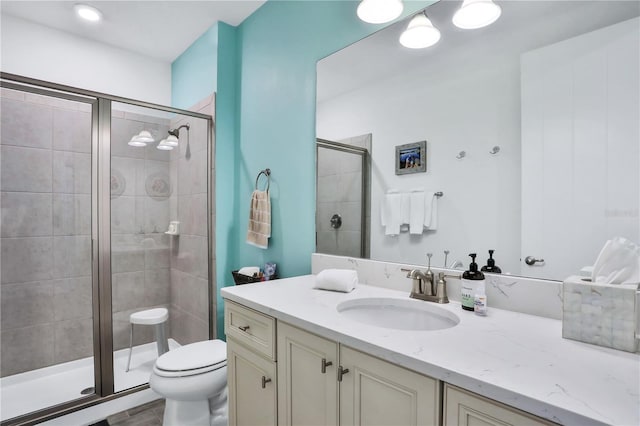 bathroom featuring walk in shower, vanity, and toilet