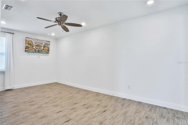 spare room with light hardwood / wood-style floors and ceiling fan