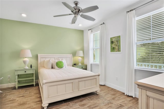 bedroom with light hardwood / wood-style floors and ceiling fan