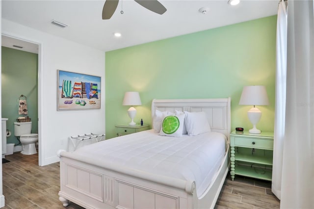 bedroom with ceiling fan, wood-type flooring, and connected bathroom