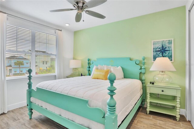 bedroom with ceiling fan and light hardwood / wood-style flooring