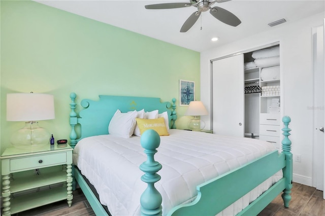 bedroom featuring ceiling fan, dark hardwood / wood-style flooring, and a closet