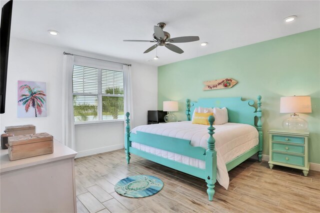 bedroom featuring ceiling fan and light hardwood / wood-style flooring