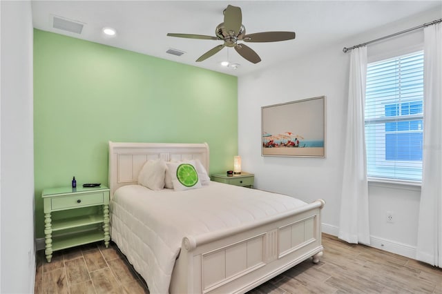 bedroom with ceiling fan and light hardwood / wood-style flooring