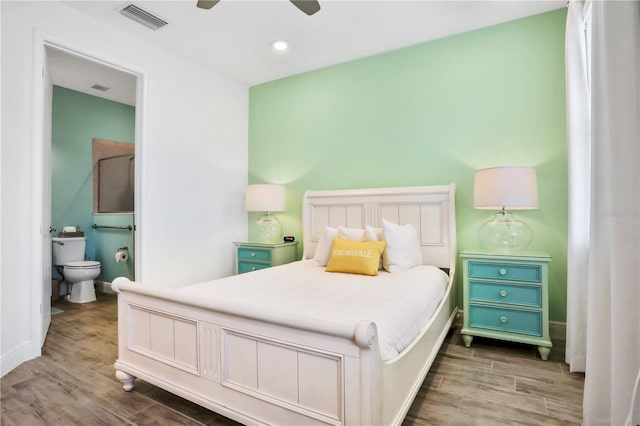 bedroom featuring connected bathroom, ceiling fan, and hardwood / wood-style flooring