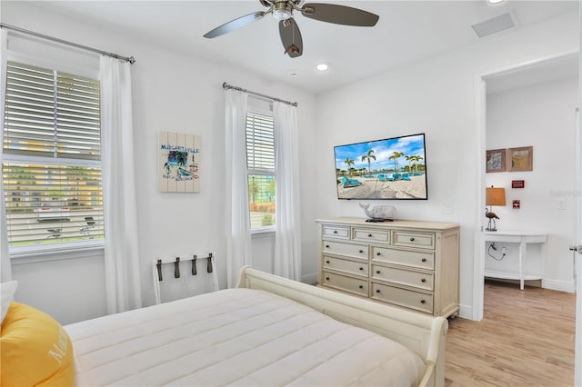 bedroom with ceiling fan and light hardwood / wood-style floors