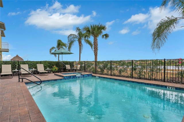 view of swimming pool with an in ground hot tub and a patio area