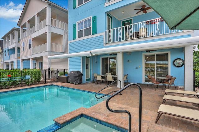 view of swimming pool with ceiling fan, a patio area, and a grill