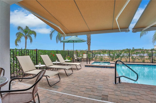 view of pool featuring an in ground hot tub and a patio