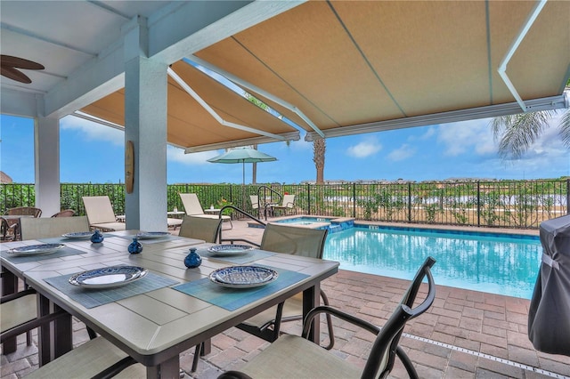 view of pool with a patio area and an in ground hot tub