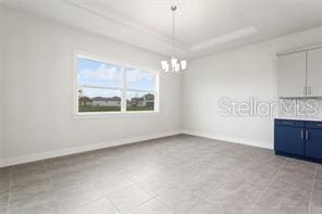 unfurnished dining area with a notable chandelier