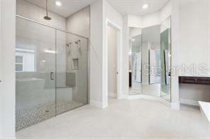 bathroom featuring vanity and a shower with shower door