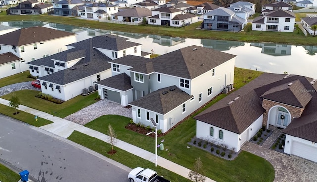 birds eye view of property with a water view