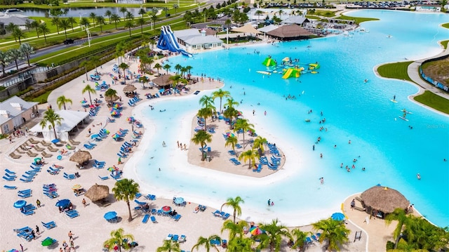 drone / aerial view featuring a water view and a view of the beach