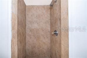 bathroom with tiled shower