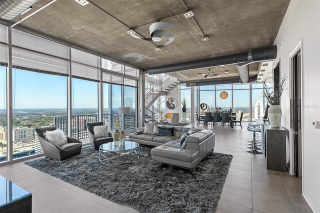 living room featuring floor to ceiling windows and ceiling fan