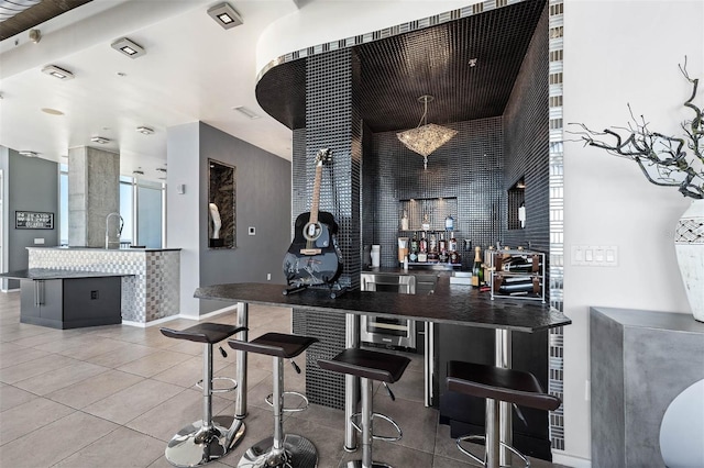 bar with tile patterned flooring and sink