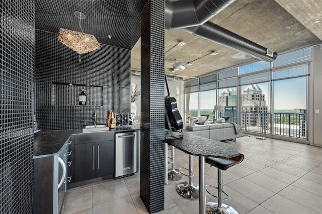 interior space with floor to ceiling windows, sink, and stainless steel dishwasher