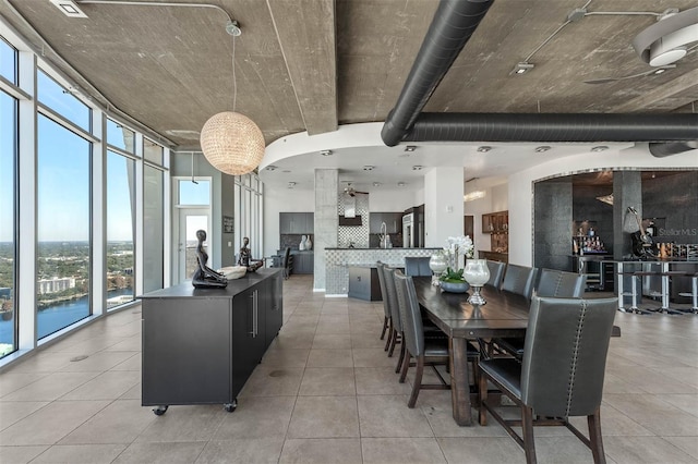 dining room with a water view and a wall of windows