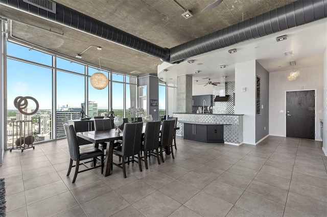 dining space with expansive windows and ceiling fan