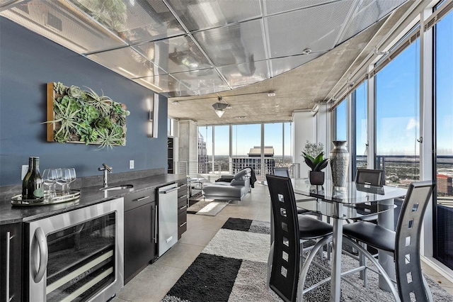 interior space with expansive windows, beverage cooler, and sink