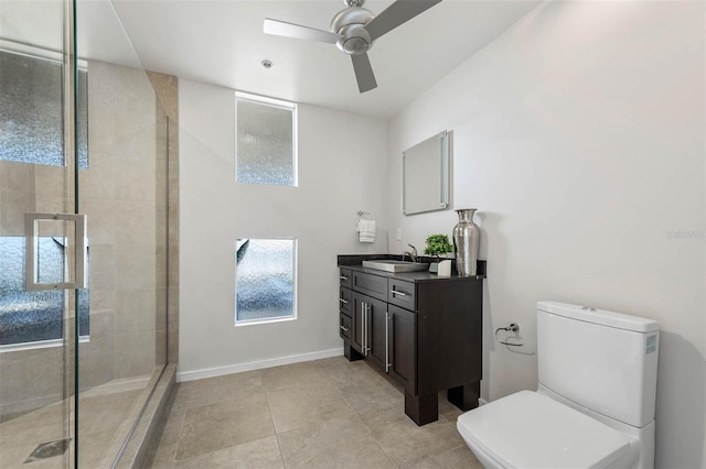 bathroom with vanity, tile patterned floors, ceiling fan, toilet, and an enclosed shower