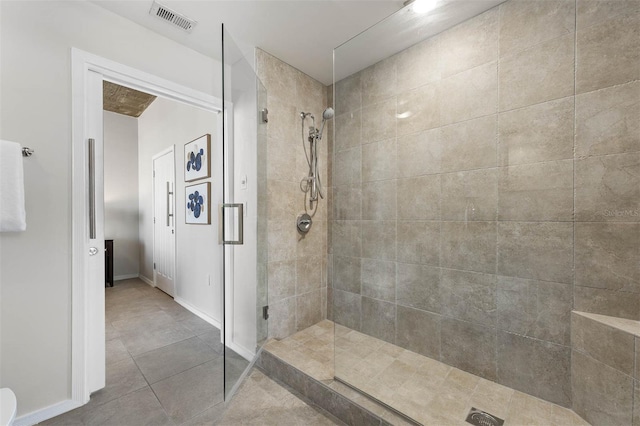 bathroom featuring a shower with door