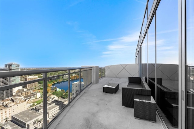 balcony with a water view and an outdoor hangout area