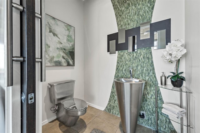 bathroom with tile patterned flooring and toilet