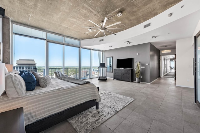 bedroom featuring expansive windows and concrete floors