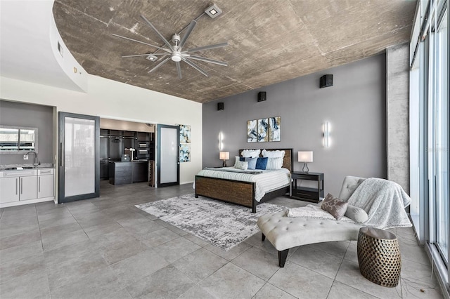 bedroom with ceiling fan and sink