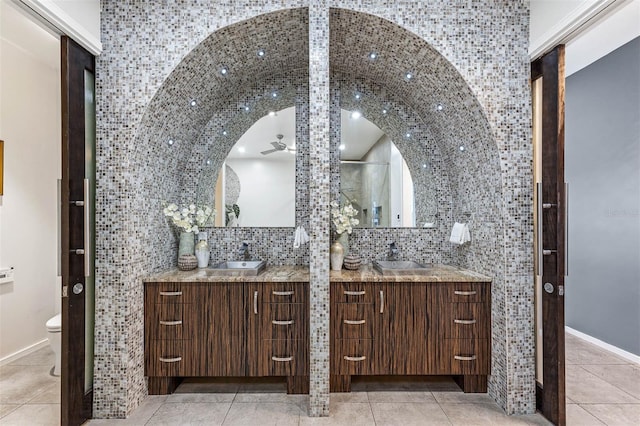 bathroom with ceiling fan, tasteful backsplash, tile patterned floors, toilet, and vanity