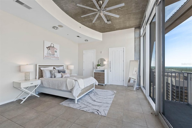 bedroom with ceiling fan, access to exterior, and a closet