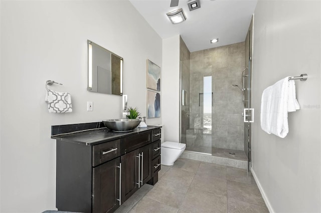 bathroom featuring tile patterned flooring, vanity, toilet, and a shower with door