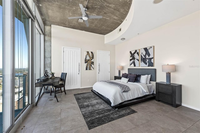 bedroom featuring ceiling fan and two closets