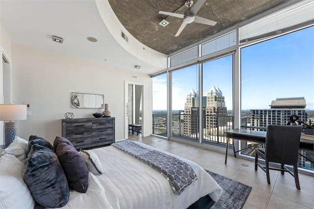 bedroom with expansive windows and ceiling fan