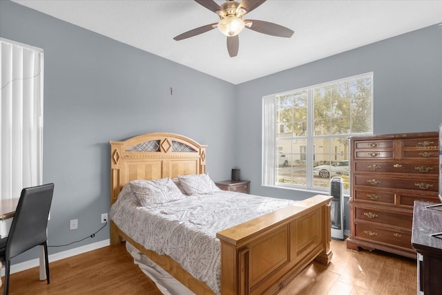 bedroom with light hardwood / wood-style flooring and ceiling fan