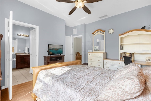 bedroom featuring ceiling fan, light wood-type flooring, and connected bathroom