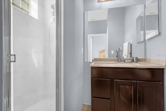 bathroom with vanity and a shower with door