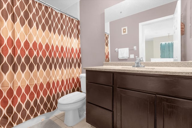 bathroom with tile patterned flooring, vanity, and toilet