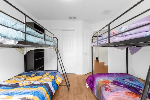 bedroom with a closet and light hardwood / wood-style flooring